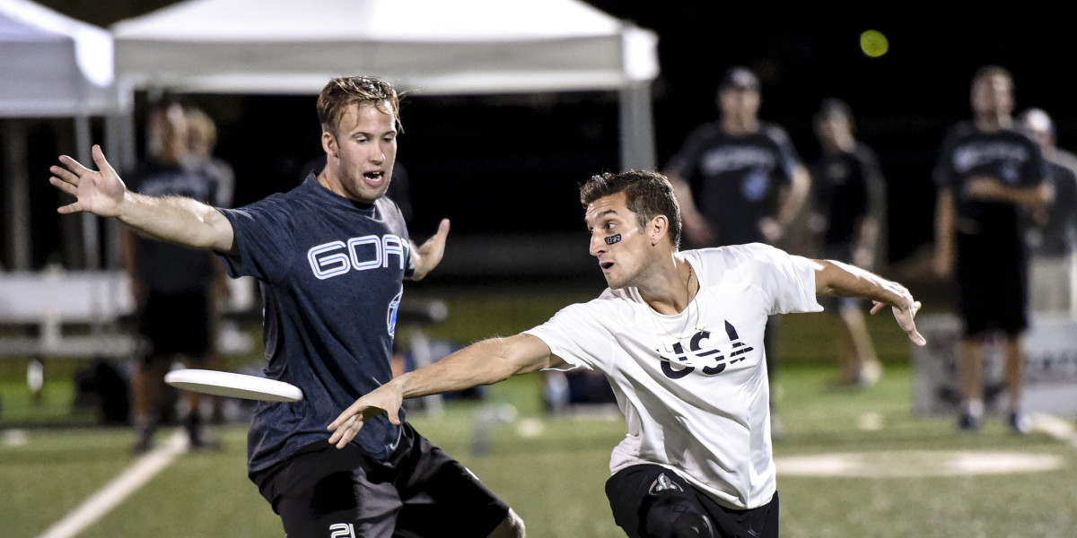Geoffrey Powell marks Kurt Gibson in the Johnny Bravo v. Goat Men's Semifinal at 2014 USAU Club Nationals. Photo by Brian Canniff, UltiPhotos.