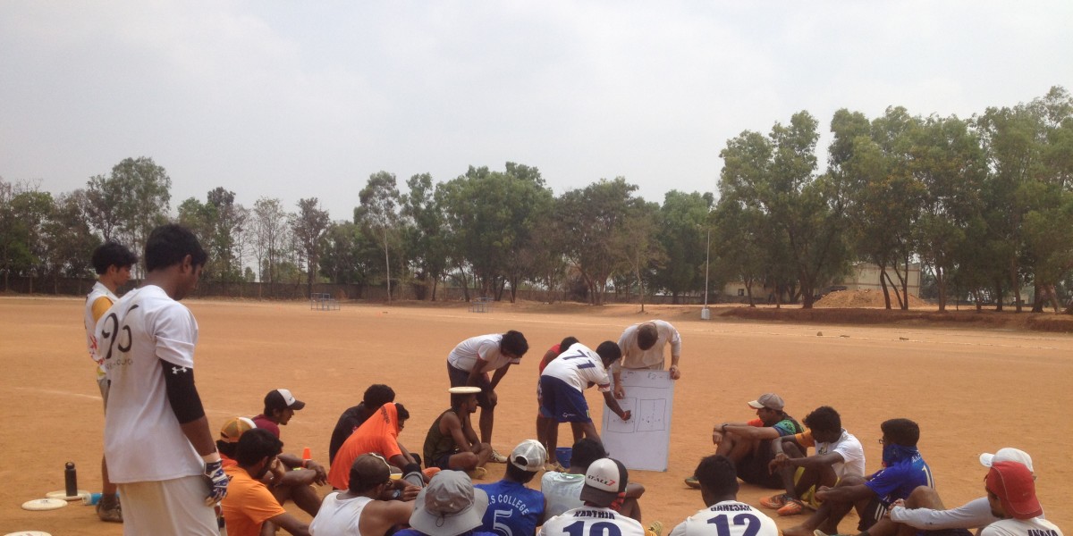 Team India Open huddled around white board at national training camp.