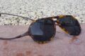 Eco-friendly tortoiseshell sunglasses with dark lenses for outdoor activities.