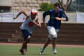 Athletes competing in a track and field event during tryouts, demonstrating speed and agility.